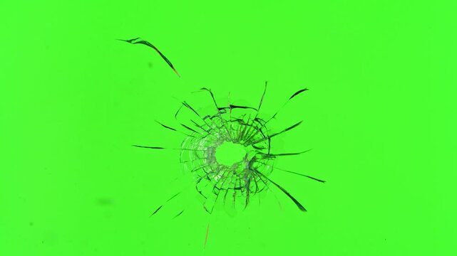 Super slow motion of gunshot through the glass, shattering against green screen background . Filmed on high speed cinema camera, 1000 fps.