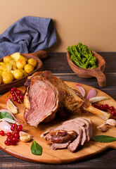Roasted leg of lamb on serving board