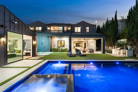 Modern luxury home with pool at dusk