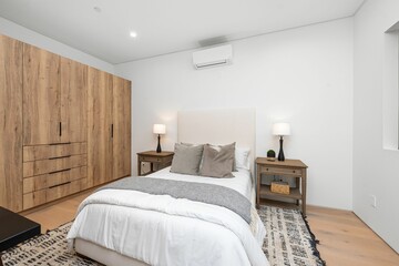 Modern bedroom interior with wooden furniture.