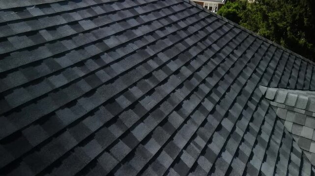 Detailed close-up of shingles on a freshly installed roof, showcasing texture and quality craftsmanship. Ideal for roofing and home improvement content.