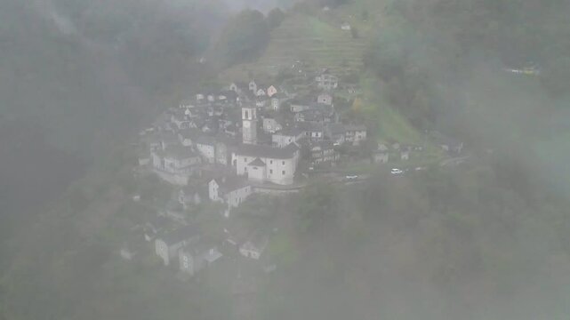 Foggy aerial view of the town of Corippo, Valle Verzasca in Ticino, Switzerland.