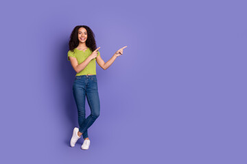 Full body photo of attractive teen woman point empty space dressed stylish green clothes isolated...