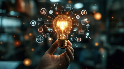 A hand holding a lit lightbulb with glowing icons surrounding it, representing ideas and innovation.