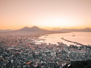Aerial view of beautiful Naples with Vesuvius in the background at sunset, Montecalvario, Italy.