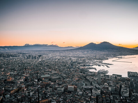 Aerial view of beautiful sunset over the cityscape of Naples with Vesuvius in the background, Vomero, Italy.