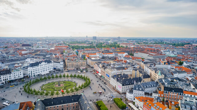Aerial view of kongens nytorv square bustling with people and surrounded by beautiful historic architecture, copenhagen, denmark.