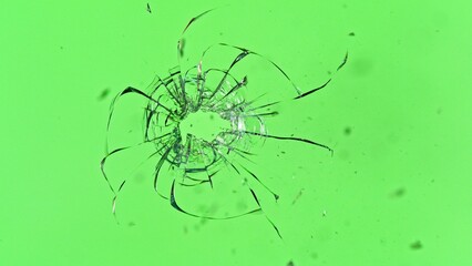 Texture of broken glassSuper Slow Motion of Shattered Glass Isolated on Green Background. Break Glass from the Gunshot. Filmed on High Speed Cinema Camera, 1000 fps. with cracks.