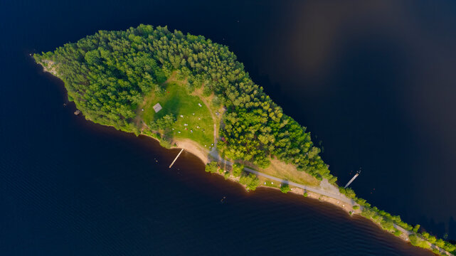 Aerial view of tranquil Siljan Lake with lush greenery and serene island, Falun, Sweden.