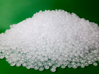 Virgin polypropylene plastic granules on a green background, this polymer is one of the main...