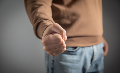 Caucasian angry and aggressive man threatening with fist.