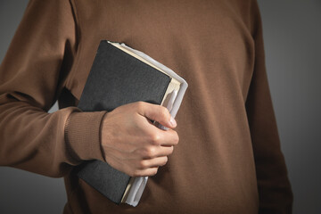 Caucasian man showing Holy Bible.