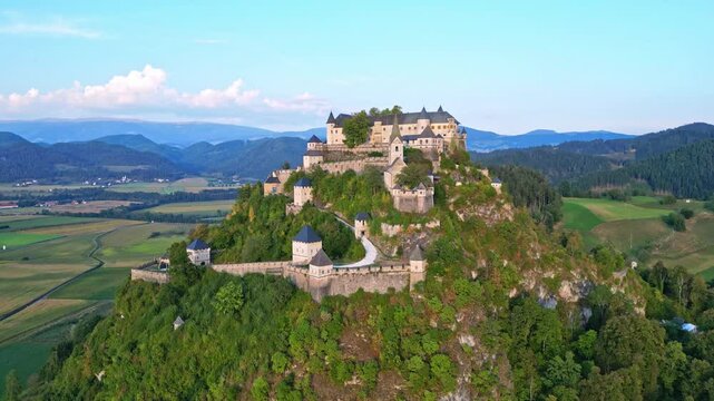 Aerial view of Hochosterwitz castle fortress surrounded by majestic mountains and picturesque valley, St. Veit, Austria.