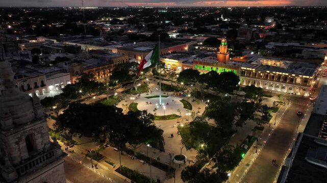 Aerial view of vibrant Merida Plaza illuminated at night with beautiful architecture and bustling atmosphere, Merida, Yucatan, Mexico.