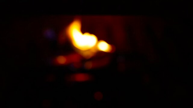 Glowing Fire in the Stone Fireplace Warm Cozy Fireplace with Real Wood Burning in it Winter and Christmas Holidays Concept. Defocus, Slow Motion