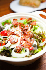 Salad with bacon and cheese and Caesar dressing