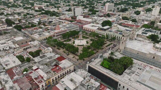 Aerial view of historic Merida Plaza surrounded by beautiful buildings and greenery, Merida, Mexico.