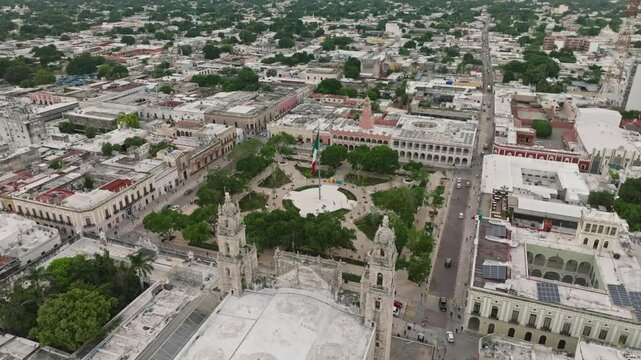Aerial view of vibrant Merida Plaza with historic cathedral and lush greenery, Merida, Mexico.