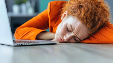 Businesswoman with her head on her desk, emotionally and physically drained, symbolizing the fatigue of burnout in corporate life businesswoman, burnout, fatigue
