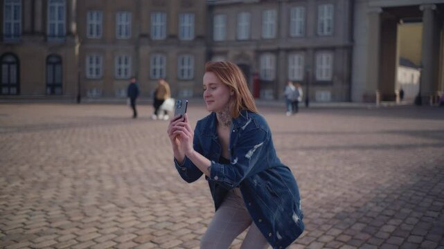 Woman Taking A Picture Of Her Friend Against The Amalienborg Palace