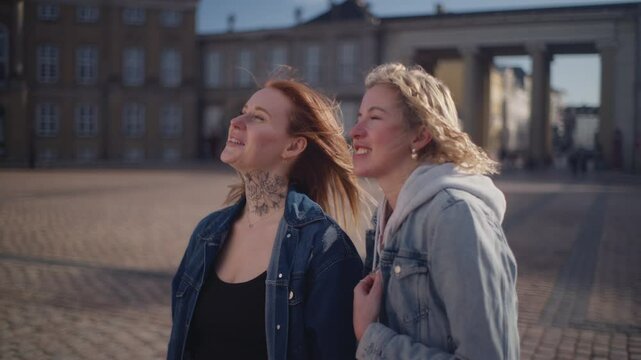 Two Tourists Enjoying The Beautiful Scenery Of Amalienborg
