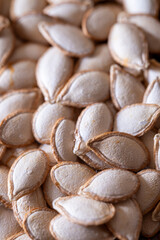  The seeds are spread out and appear to be in various sizes. Concept of abundance and variety, as the seeds are scattered across the entire frame