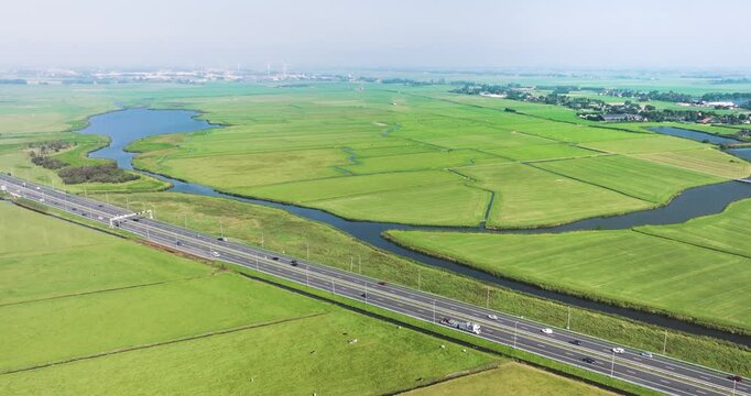 Aerial view of serene meadow bird reserve Het Die with vibrant fields and a tranquil canal, Limmen, Netherlands.