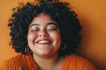 Closeup Portrait Of A Happy And Confident Young Overweight Woman Against Orange Background. Confident Smiling Woman Closeup