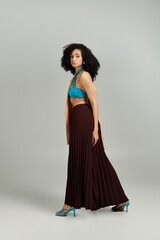 Fototapeta premium A fashionable woman poses confidently in a chic outfit, embodying contemporary style.