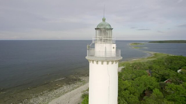 Aerial view of the iconic lange erik lighthouse on a rocky shore beside the calm baltic sea, oland island, sweden.