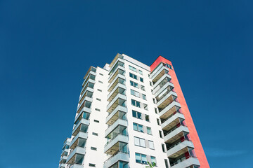Low angle view of tall building against blue sky