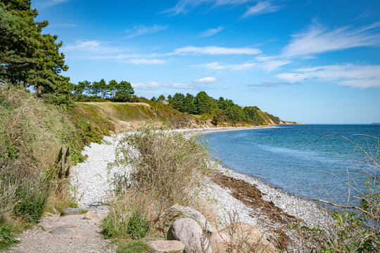 Tranquil Coastal Landscape with Clear Blue Water and Pebble Beach