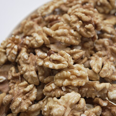 Close-up view of walnut halves, showcasing the intricate details and textures of these nutritious nuts. The image highlights the natural beauty and richness of walnuts