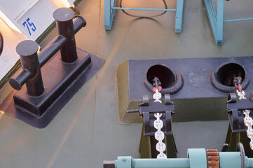 A reel with a wound steel cable on the stern of a motor ship against the background of seething water. The ship's movement.