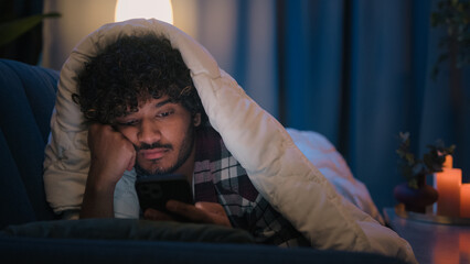 Sad sleepy guy Latino tired man upset Arabian sleeping napping boring Indian male at night evening...