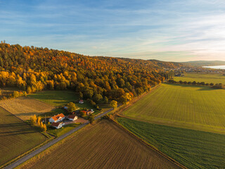 Typical swedish countryside landscape in autumn colors, at sunset, aerial view, near lake Vättern. Beautiful autumn foliage. 