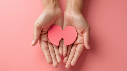 Fototapeta premium Hands holding kidney shaped paper, world kidney day, National Organ Donor Day, charity donation concept
