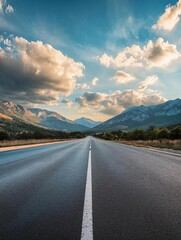 Empty Road Stretching into Mountains Under Dramatic Sky