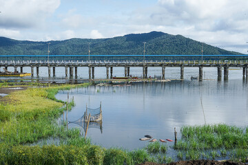 View of the bridge in the harbor with mountains in the background