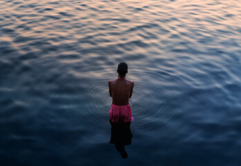 Varanasi, India - 24 January 2017: View of serene River Ganges at sunset with reflections and ripples, Varanasi, India.