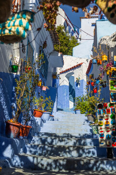 View of vibrant blue city with charming narrow streets and decorative pots, Chefchaouen, Morocco.