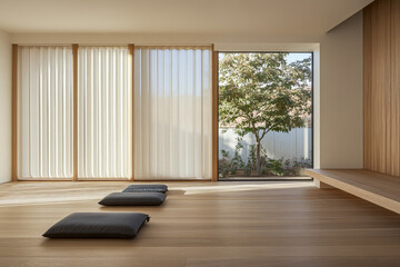 Fototapeta premium Minimalist indoor seating area with natural light and sliding doors leading to a serene garden