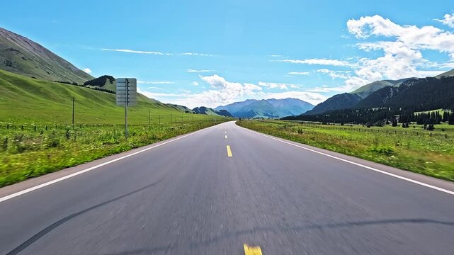 Driving a car on Duku Highway. Duku Highway is the most beautiful highway in Xinjiang, China.
