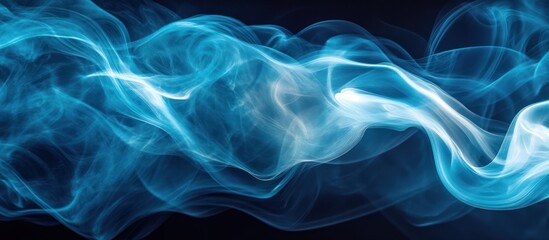 Fototapeta premium Abstract blue smoke swirls on a dark background.