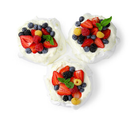 Pavlova cake (meringue dessert) with whipped cream, fresh berries and mint isolated on white, top view