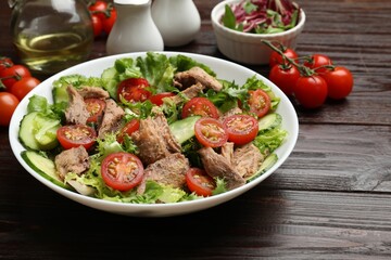 Delicious fresh tuna salad on wooden table, closeup