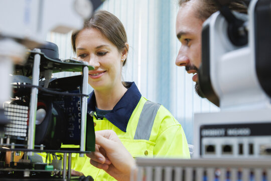 automation machine engineer students study and inspection control robot arm machine in robotics engineering academy at university or factory workshop. AI robot technology, future innovation trend.