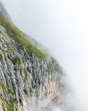 View of a Mountain Vally in The Dolomites filled with clouds, Province of Trento, South Tirol, Italy