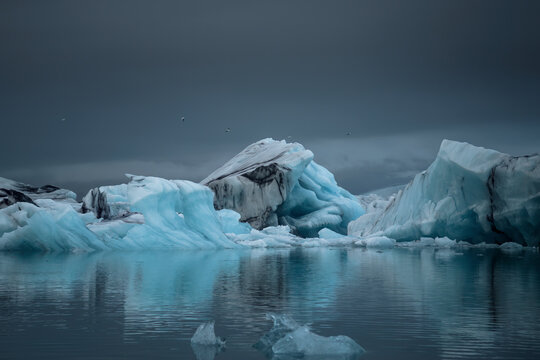 View of Jokulsarlon glacier lagoon with majestic icebergs and serene reflections, Vatnajokull National Park, Iceland.