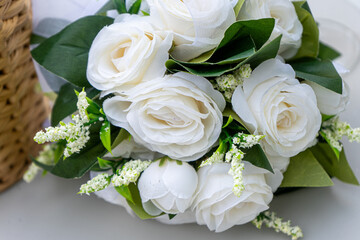 A stunning bridal bouquet featuring elegant artificial white roses, perfect for weddings and romantic occasions. Soft petals and lush greenery create a timeless, classic look.